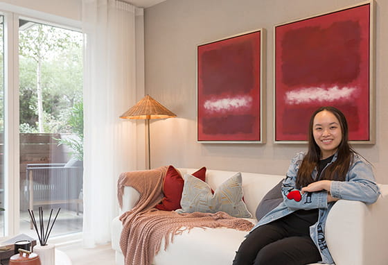 An image of Aurora sat on the sofas at their new home