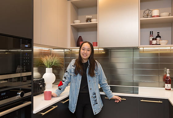 An image of Aurora stood in their new kitchen
