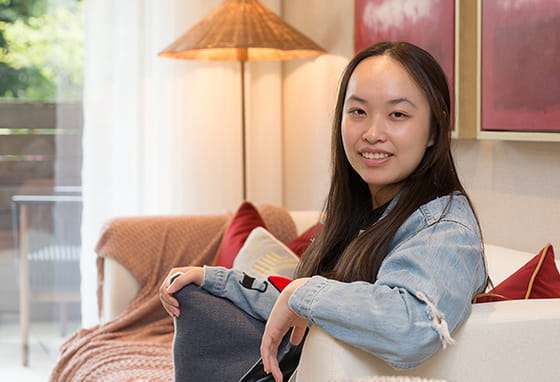 An image of Aurora sat on the sofa at their new home