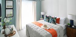 Bedroom image with turquoise walls and white furniture