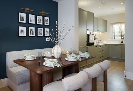 Dining area with kitchenette in background