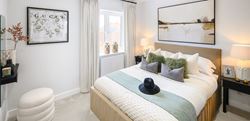 Foal Hurst Green bedroom with a large central double bed and neutral design