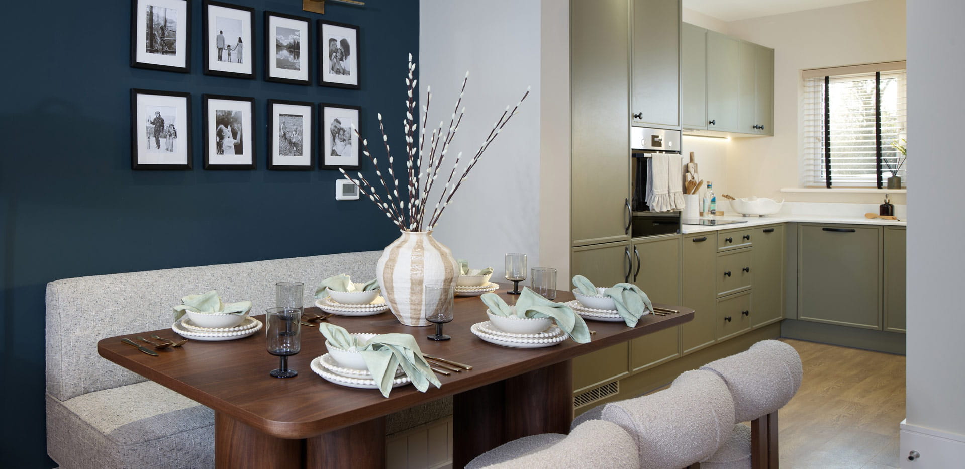 Dining area with kitchenette in background