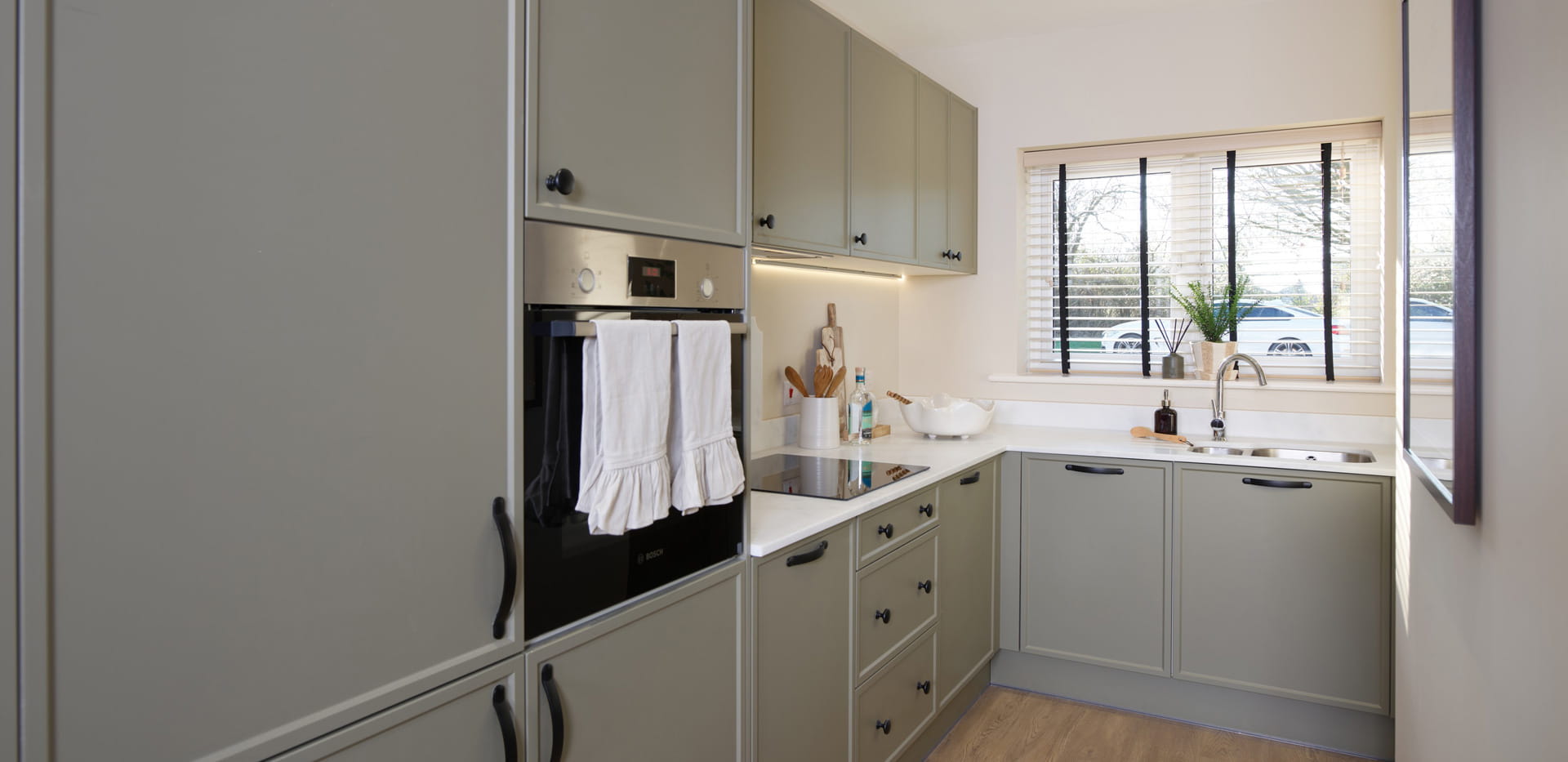 Kitchenette with light grey cabinets and cupboards