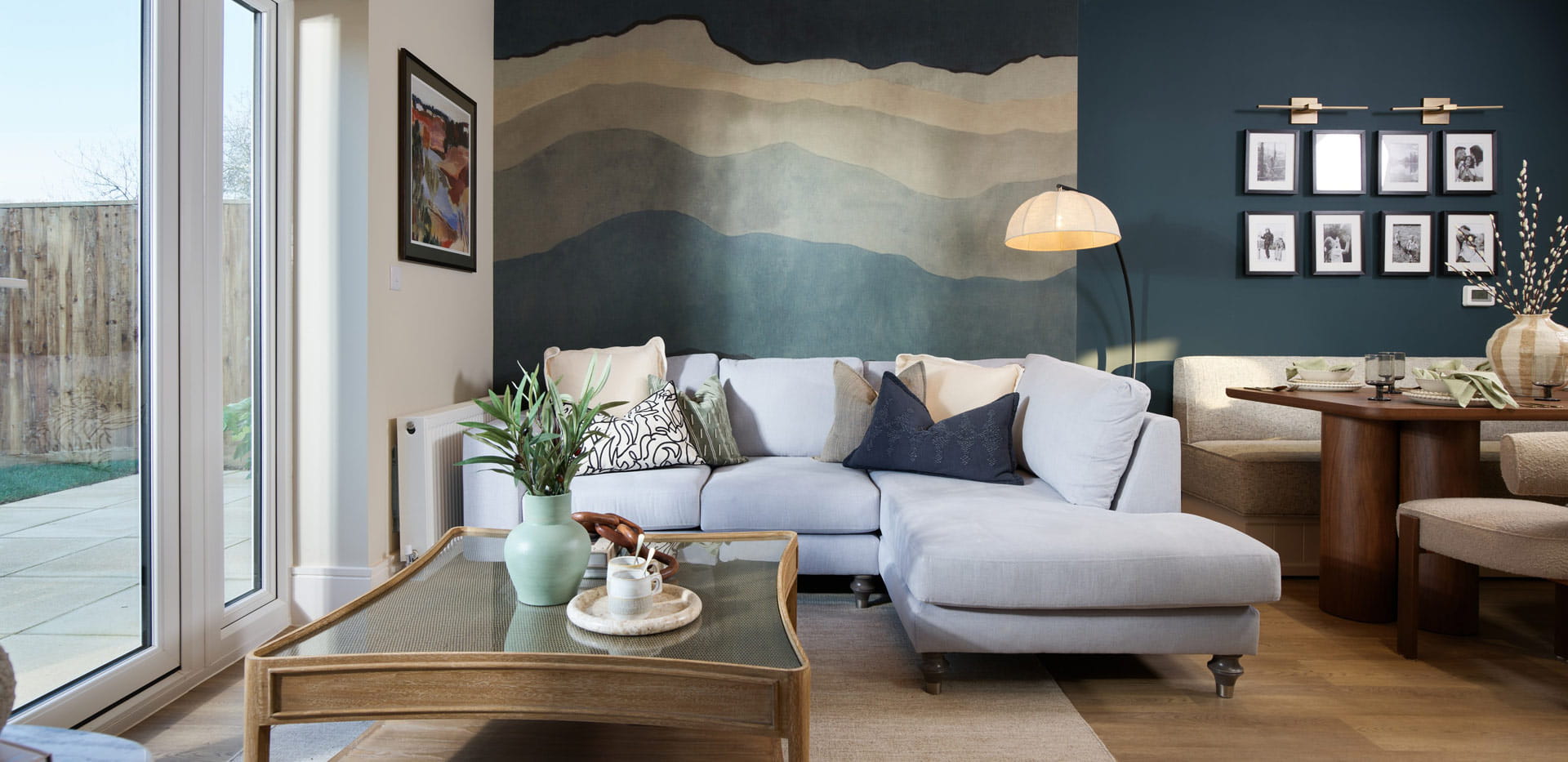 Living space with sofa and coffee table, patio doors and dining area adjacent