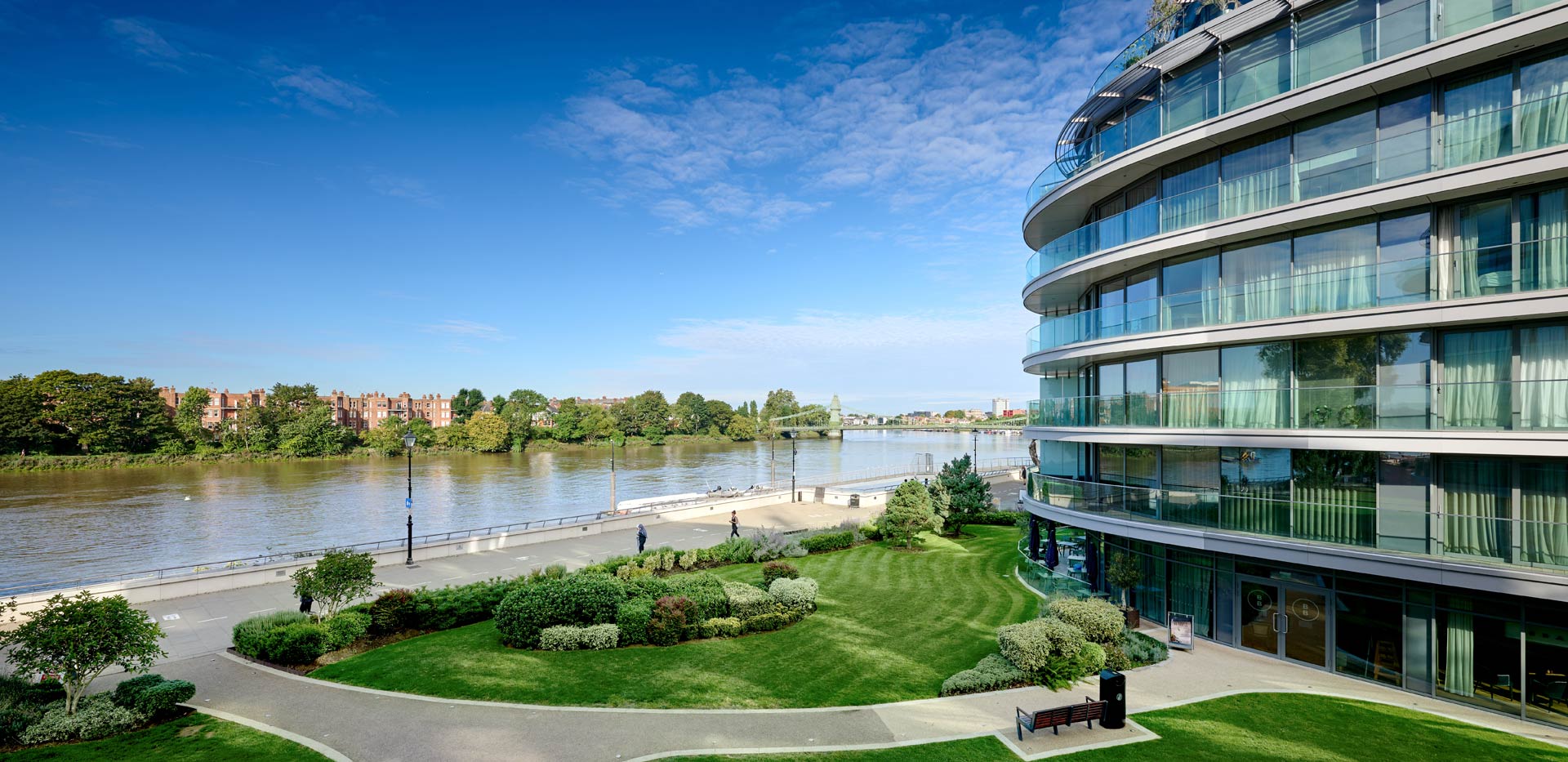 CGI of new build development alongside scenic river view.