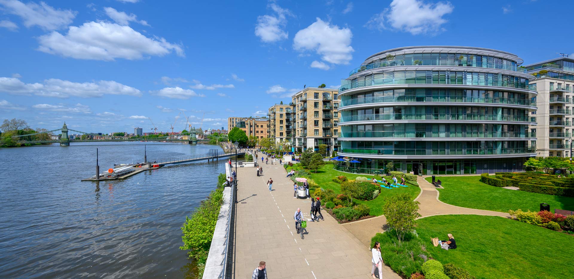 CGI of new build development alongside scenic river view.
