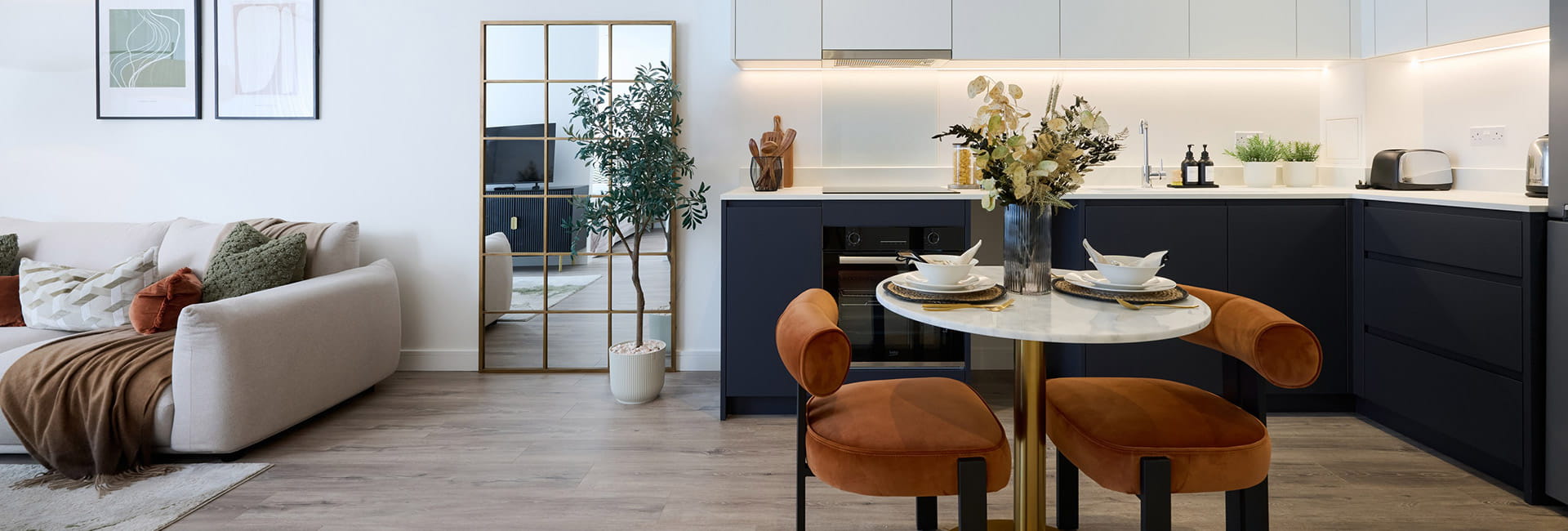 Fulham Reach home - circular dining table, spacious kitchen and living area sofa in the background