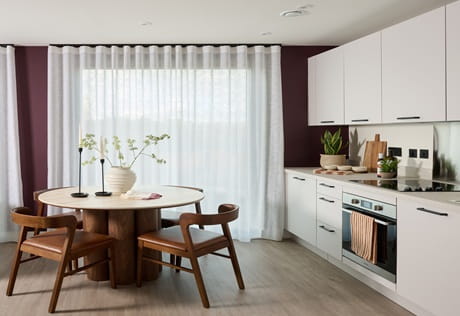 Decorated kitchenette and dining space, tall windows for ample natural lighting
