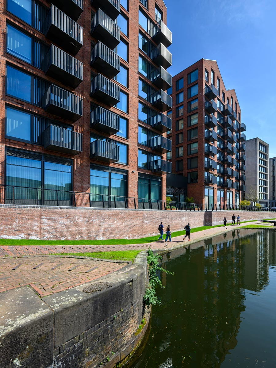 Closeup shot of canalside and new build flats adjacent