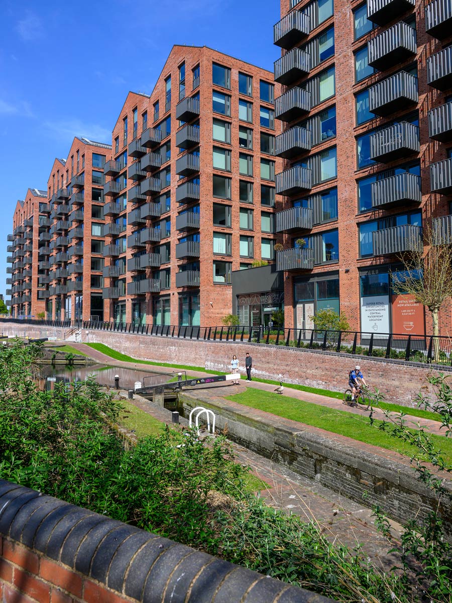 Closeup shot of canalside and new build flats adjacent