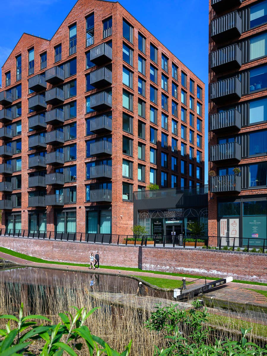 Closeup shot of canalside and new build flats adjacent
