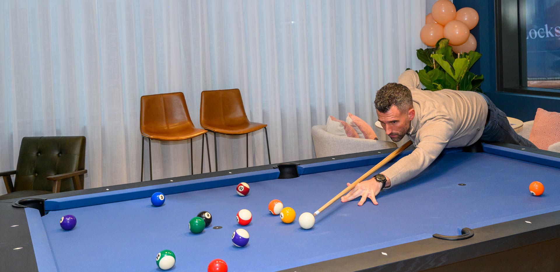 Glasswater Locks resident facilities showing a person playing pool