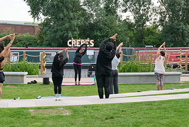 A yoga class on the canalside.