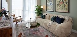 Living area painted in sage with cream sofa