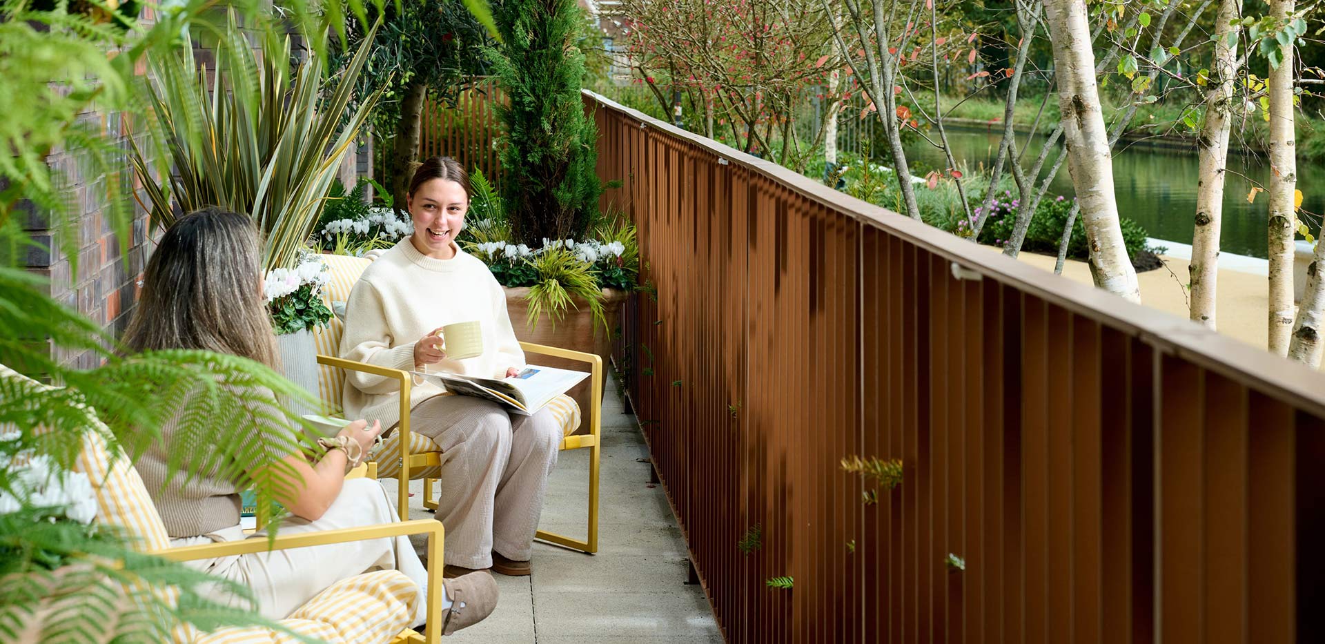A picture of two women drinking coffee on their balconies