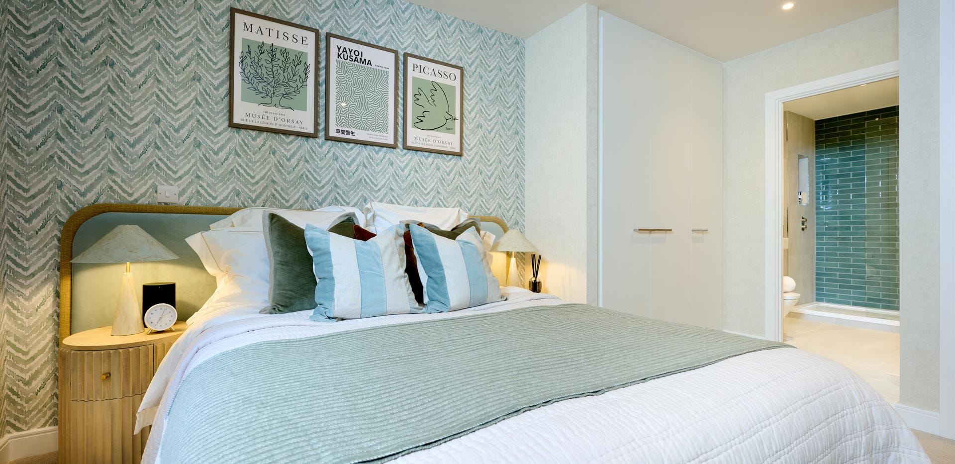 Double bed with contemporary design, bedside tables and wall hanging