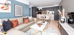 The Longwater Collection apartment living area with an aqua blue wall and large corner sofa