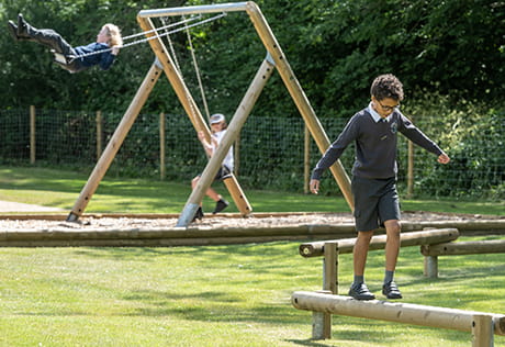 Image of a child playing in a playground on a warm Summer's Day
