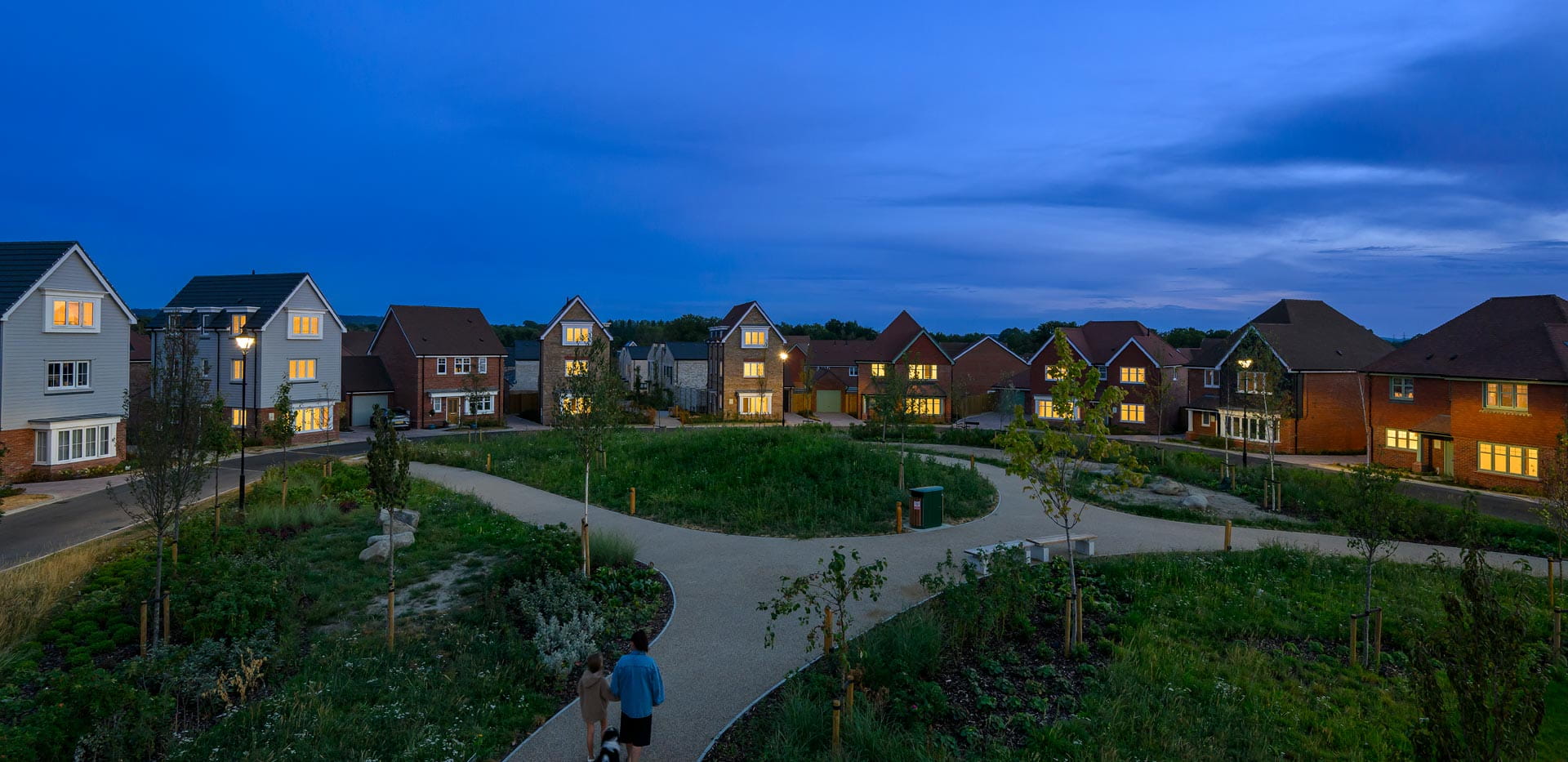 New build homes in the evening with well maintained grassed path in front.