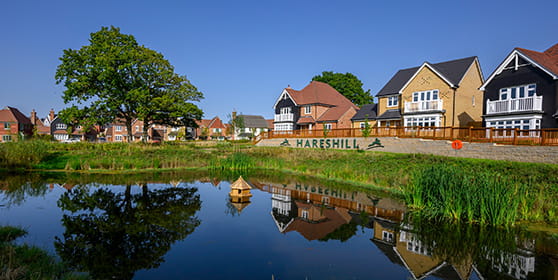 An exterior street scene of Hareshill boasting their stunning lake and open space