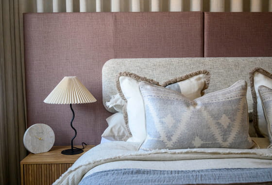 Closeup of made-up bed and bedside table