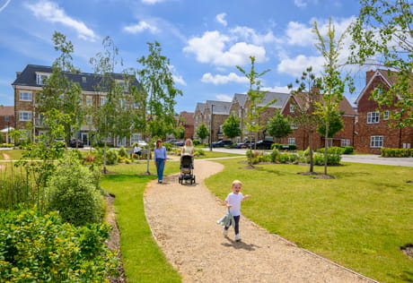 Pedestrian path and grassed areas, with new development in background