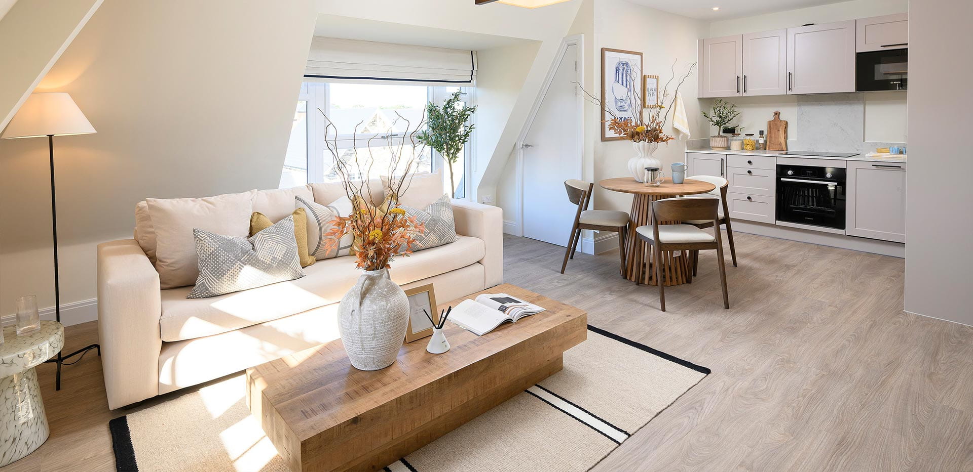 An interior Living / Dining / Kitchen image at the 1 Bedroom Show Apartment at Hartland Village