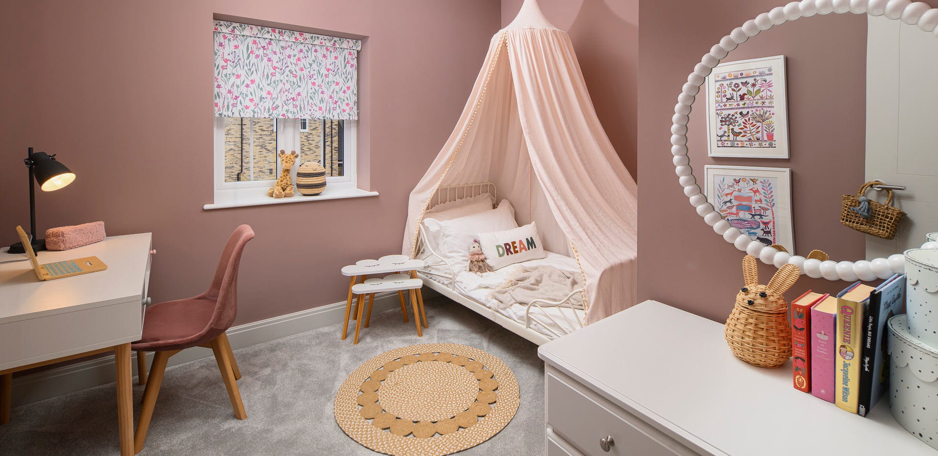 Bedroom decorated for young child, with desk and vanity table