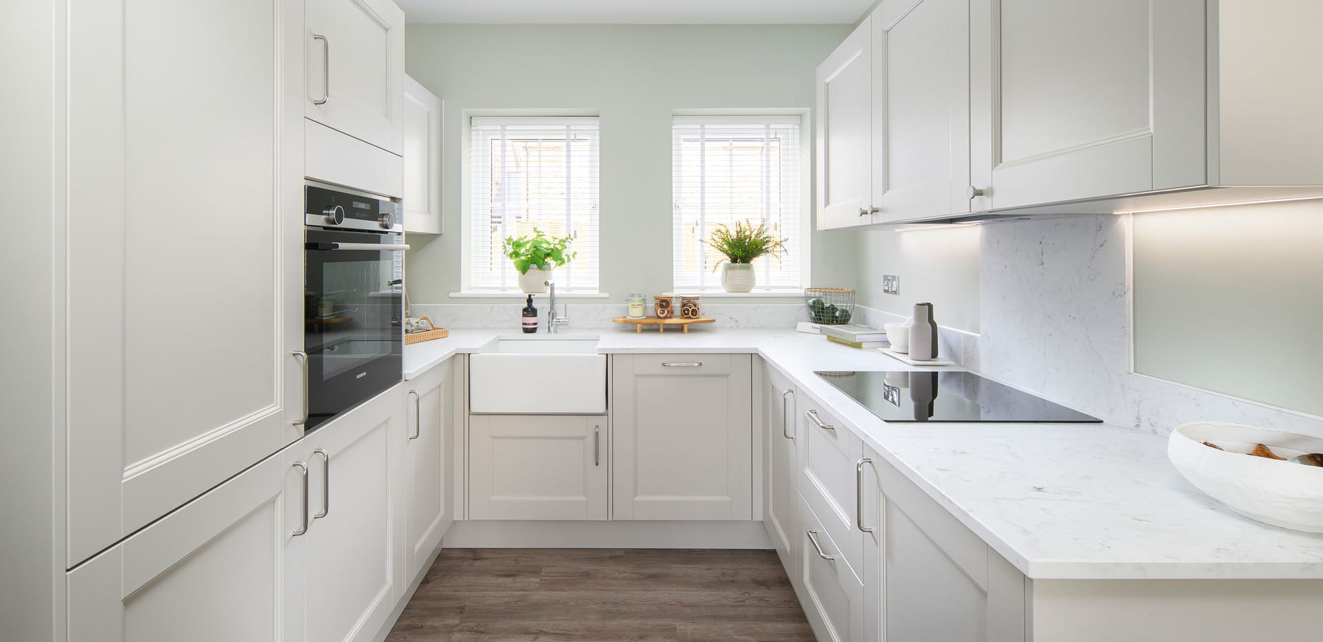 Kitchenette with white cabinets, drawers, cupboards and counter tops