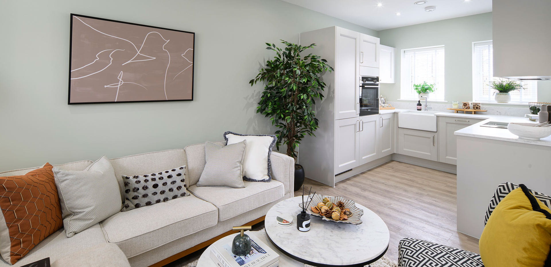 Decorated living space and kitchenette in background
