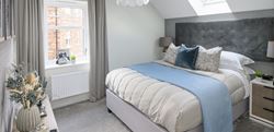 Hartland Village master bedroom with elegant blue and grey decor
