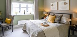 Hartland Village bedroom with yellow and sage decor
