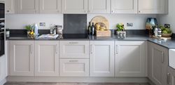 Hartland Village kitchen with white cupboards and grey countertops