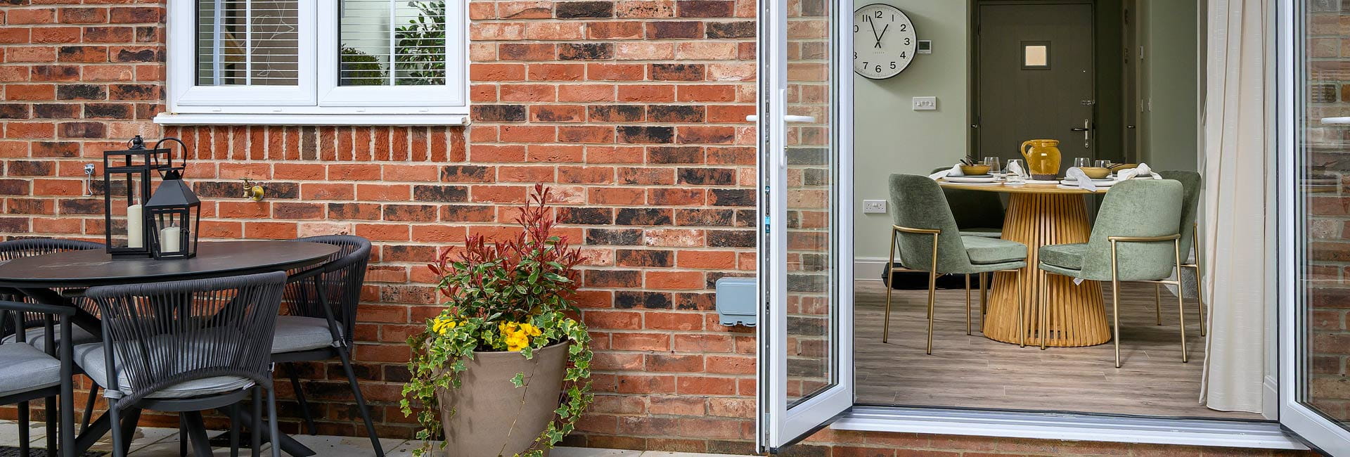 Rear garden patio, with garden furniture and access to kitchen dining space.
