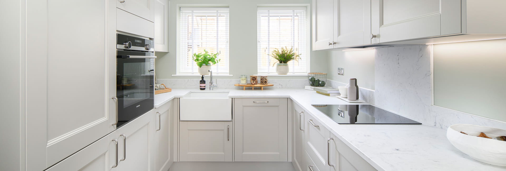 View into kitchen with white panels and countertops.