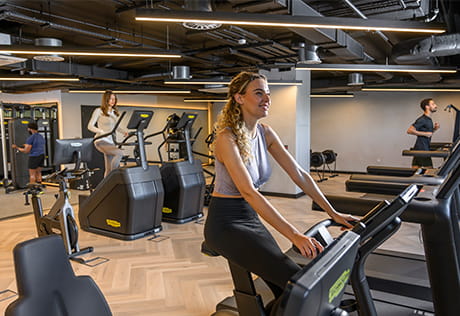 People in the gym on cardio machines