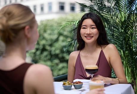 An image of women sat down with drinks having a chat