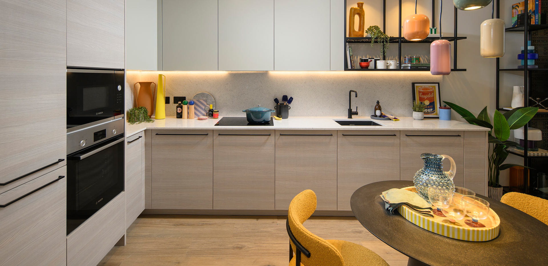 Kitchen, beige cupboard panels and white countertops, modern appliances.