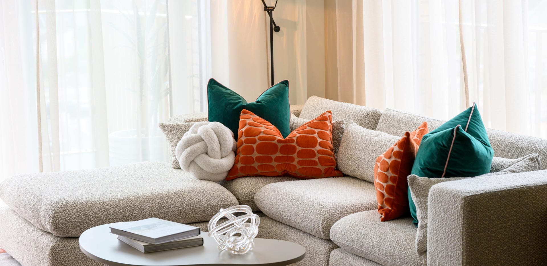 Fabric chaise lounge in white, circular coffee table.