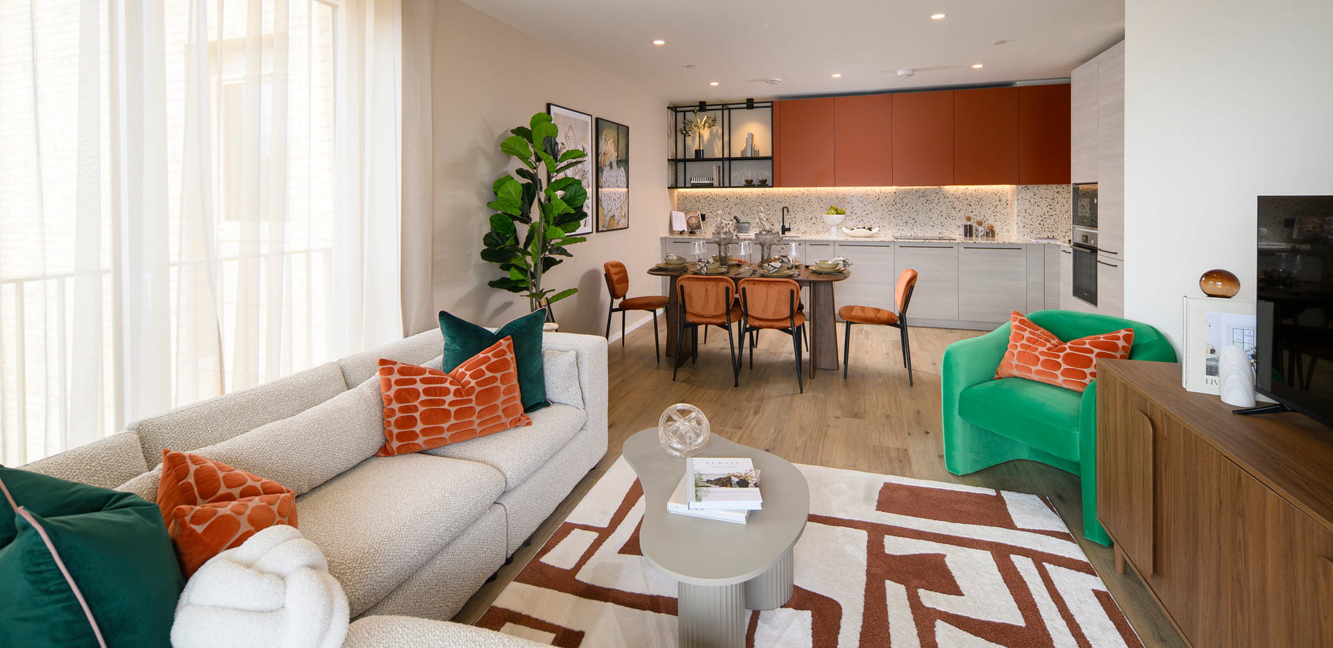 Living space in foreground, dining area and kitchen in background.