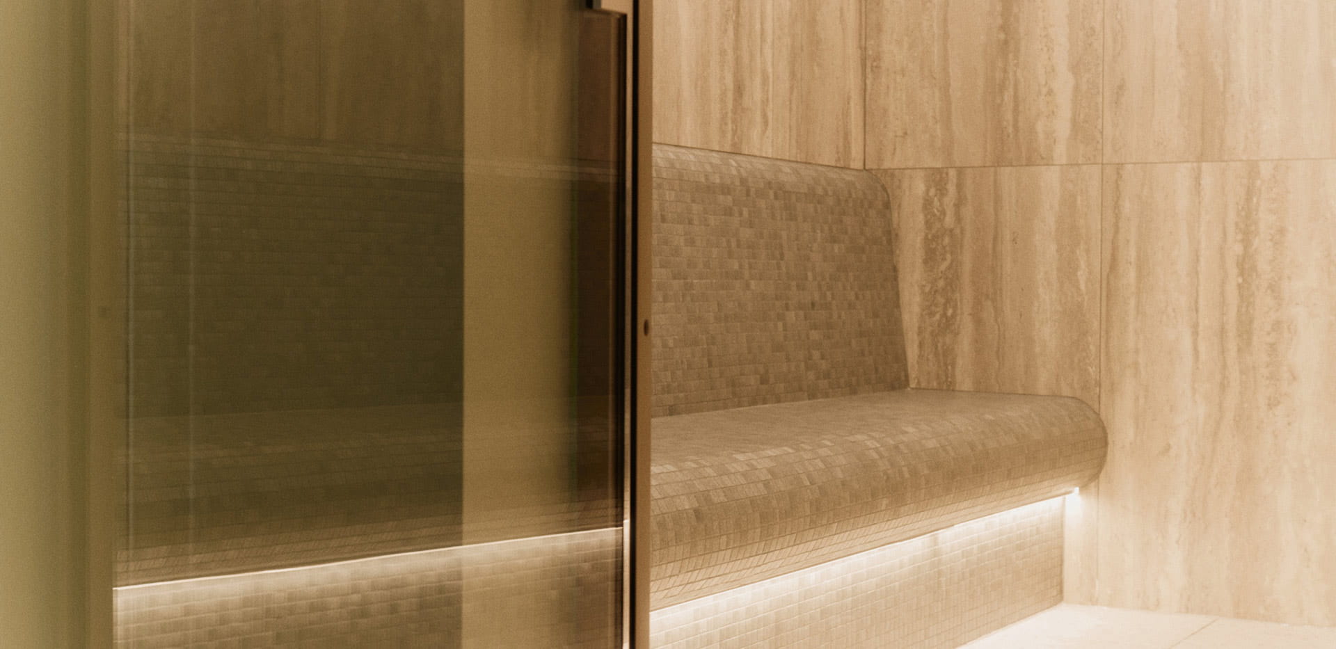 Closeup of glass smoke-pattern door leading to wet-steam spa room.
