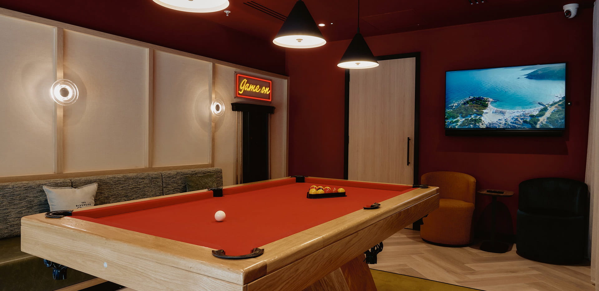 Pool table and wall mounted TV in an entertainment room.