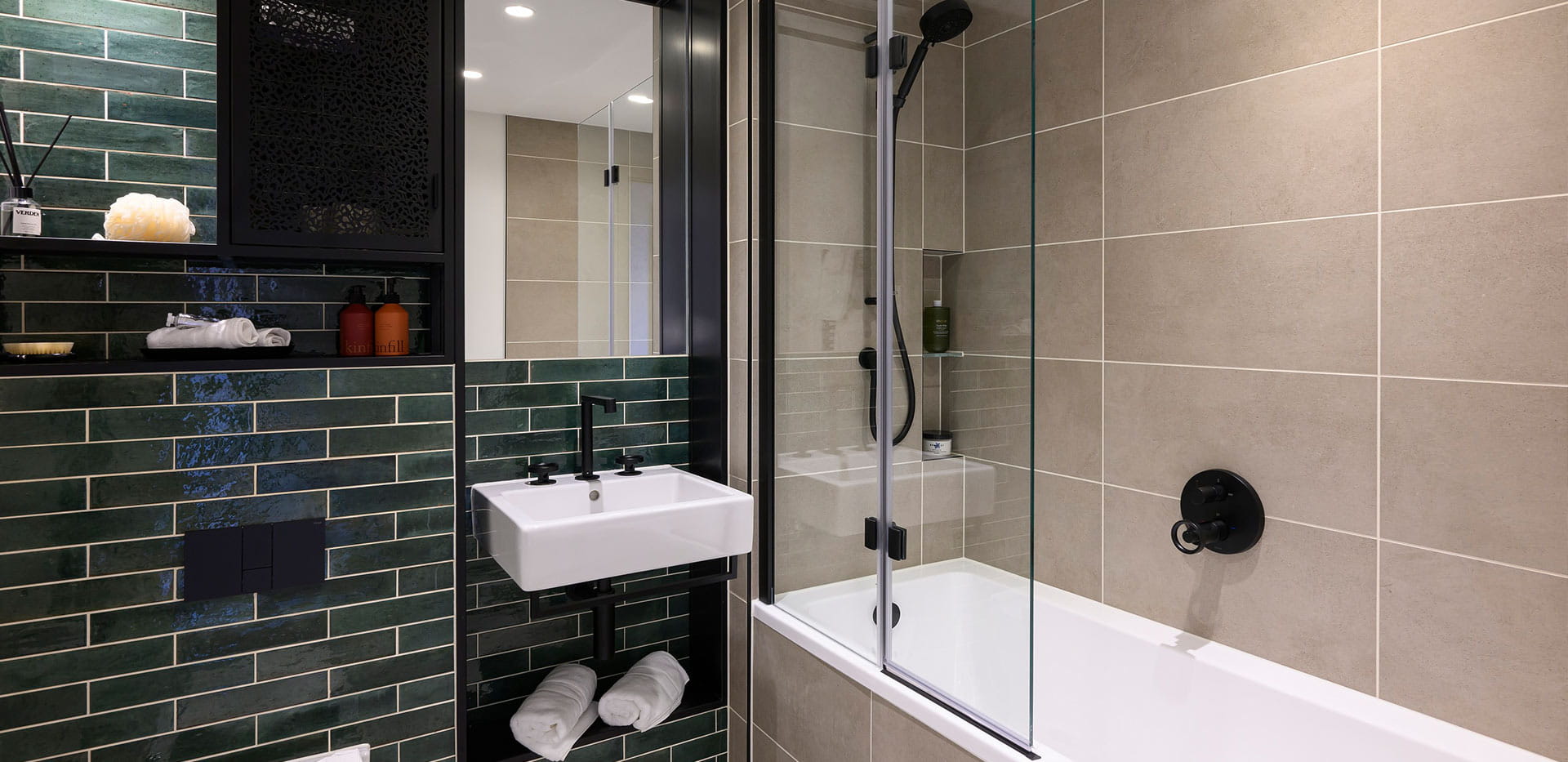 An image of a Bathroom with green titles at Heron Wharf