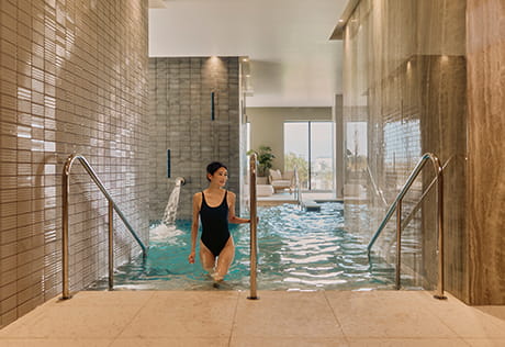 An image of a women walking out of the pool