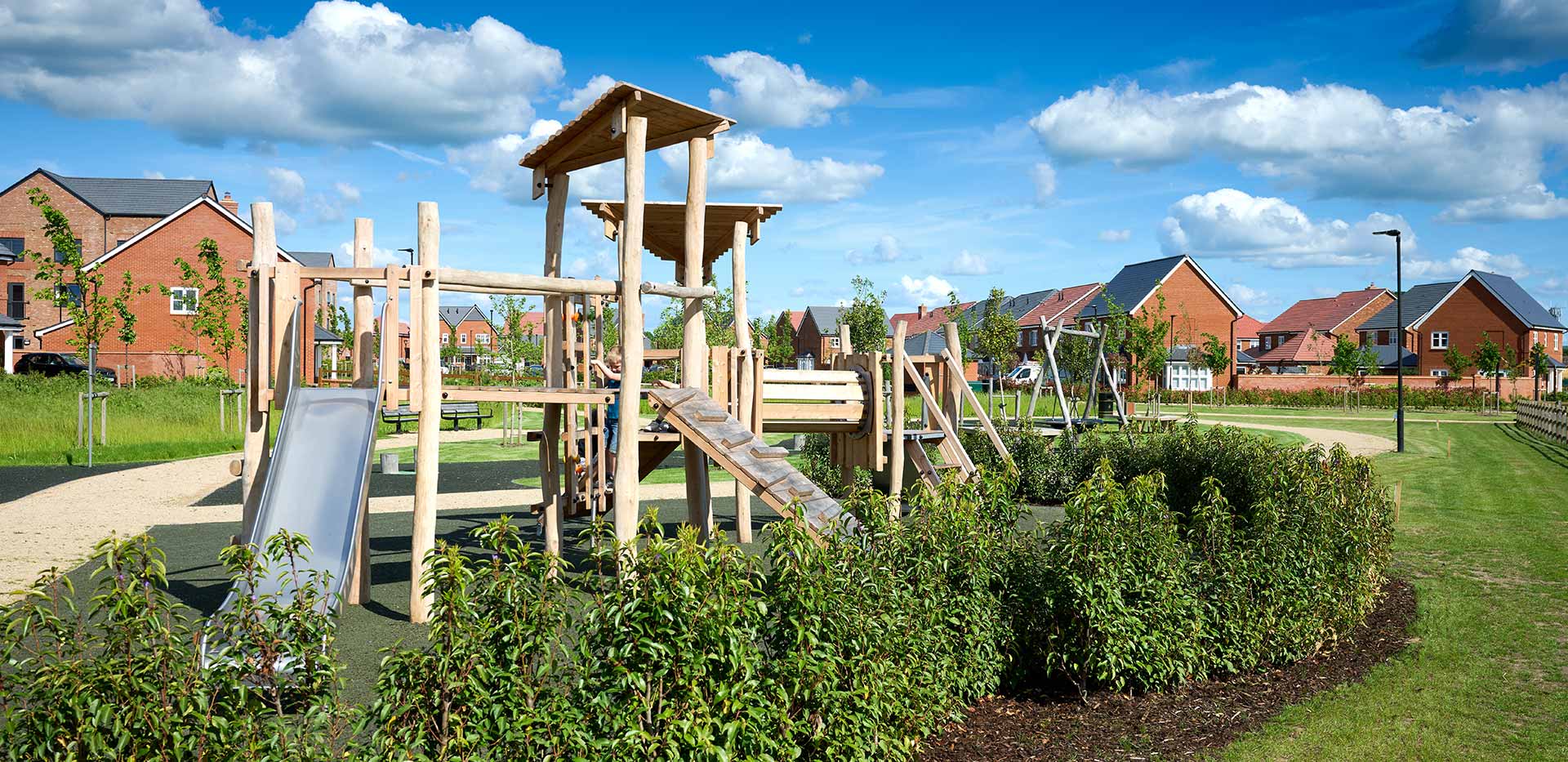 Image of children playing at a playground at Highcroft