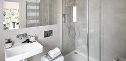 Dareham Court bathroom with shower and grey marble