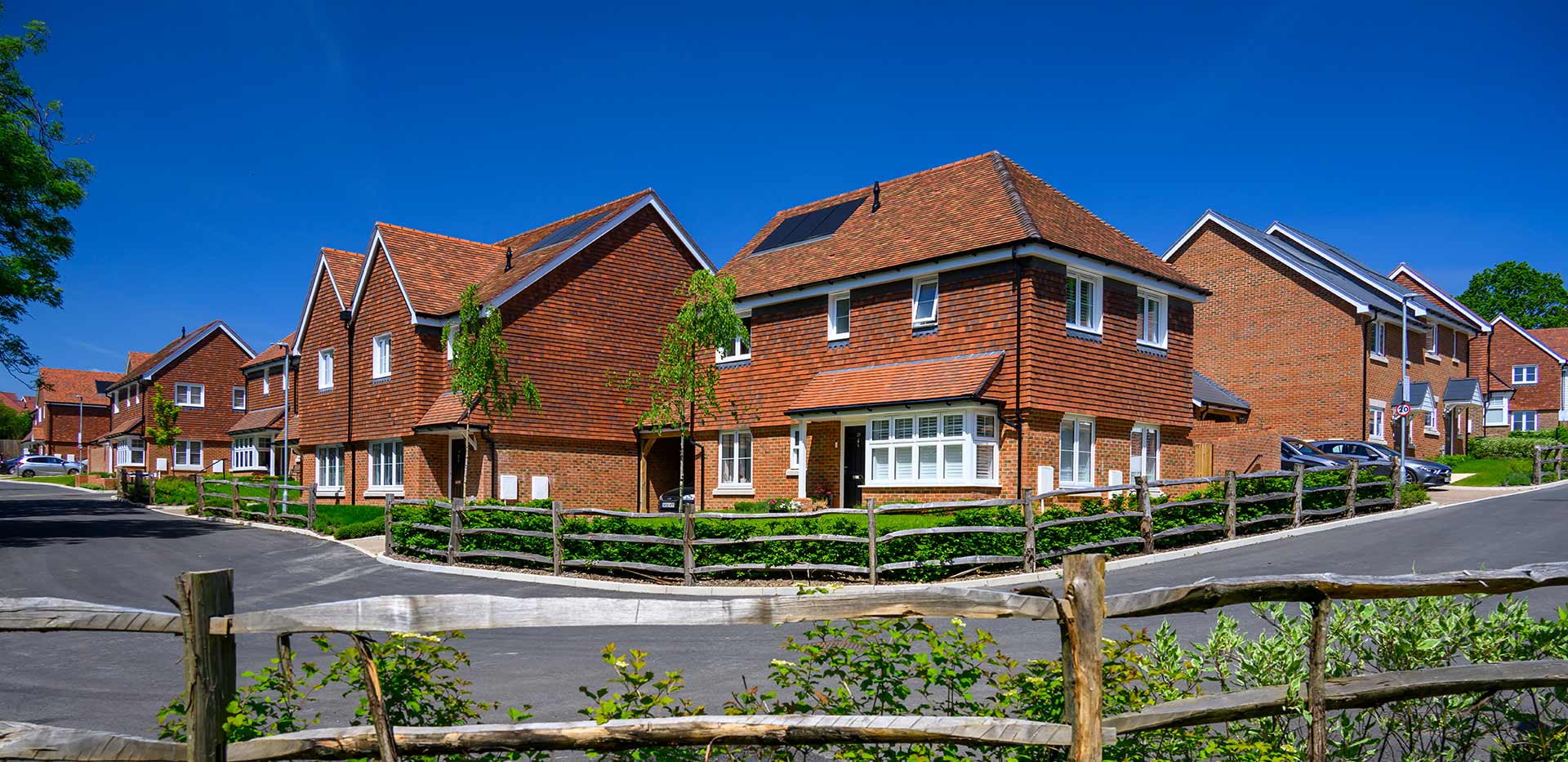 Hollyfields exterior development photo featuring street and houses