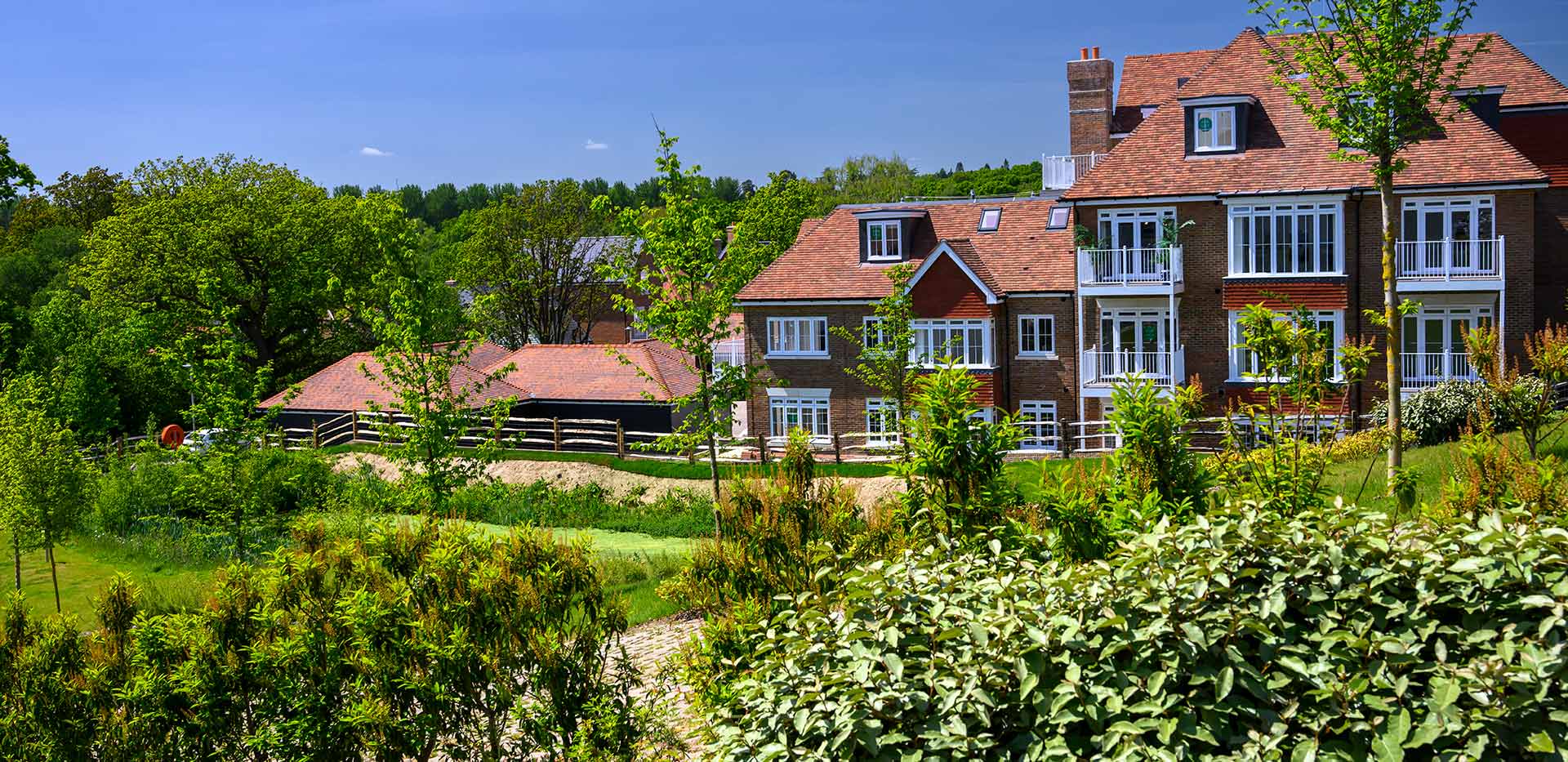 Hollyfields exterior photo of apartments and gardens