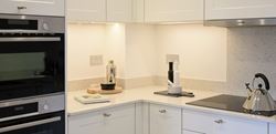 Hollyfields two bedroom apartment kitchen with a white theme